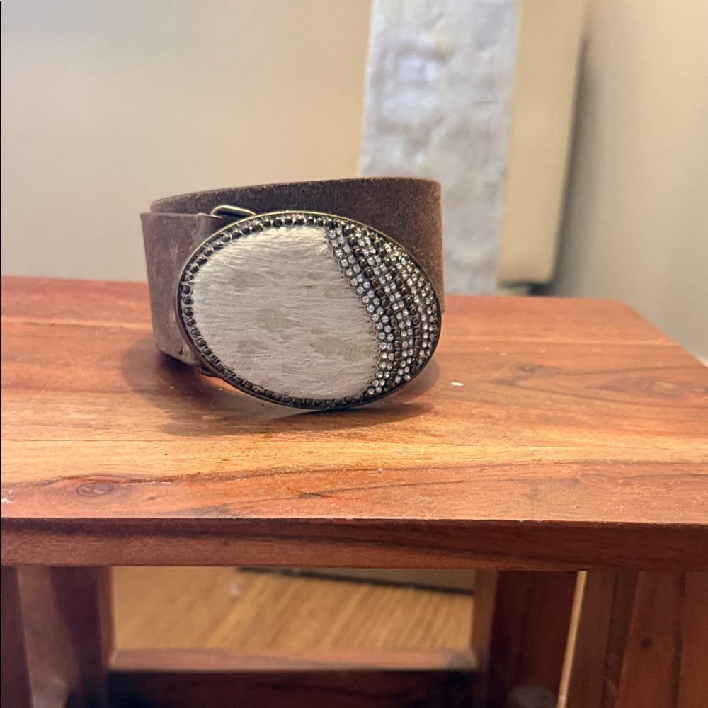 Brown Leather Belt with Silver Oval Crystal Accent. Buckle features cowhide.